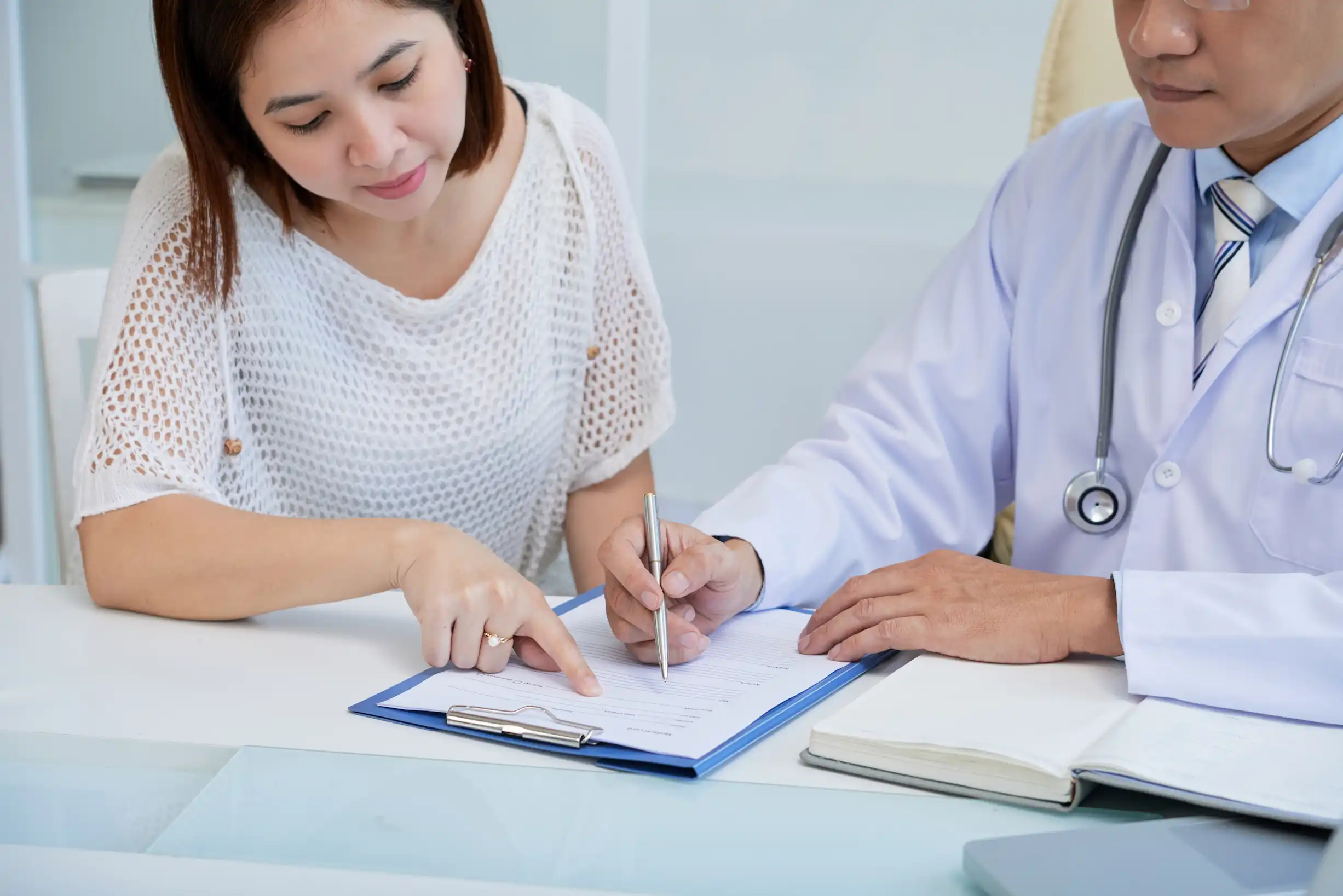 Physician and clinical documentation specialist discussing patient chart integrity